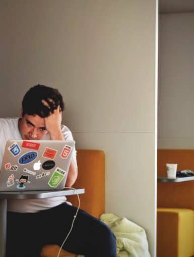 Gestresster Student mit Laptop