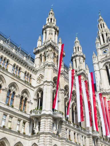 Das Wiener Rathaus von außen. Geschmückt mit österreichischen Fahnen.