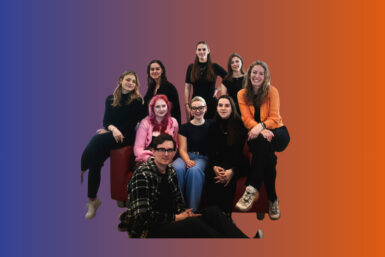 Das neue SOFA Team 2025 auf einem roten Sofa. Im Hintergrund sind die Farben der CI zu erkennen: blau und orange.